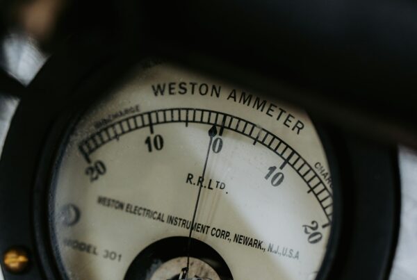 Analog ammeter needle resting at zero on a scale marked in both directions